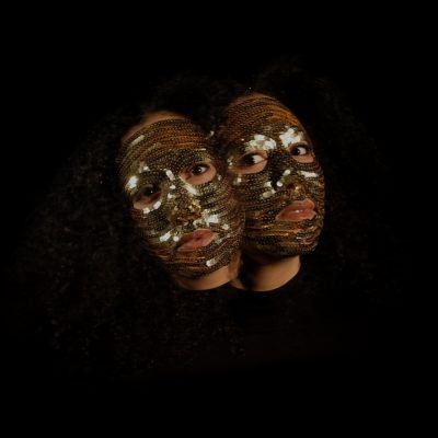 Photograph of Ashanti Harris. Headshots of the artist wearing sequin masks.