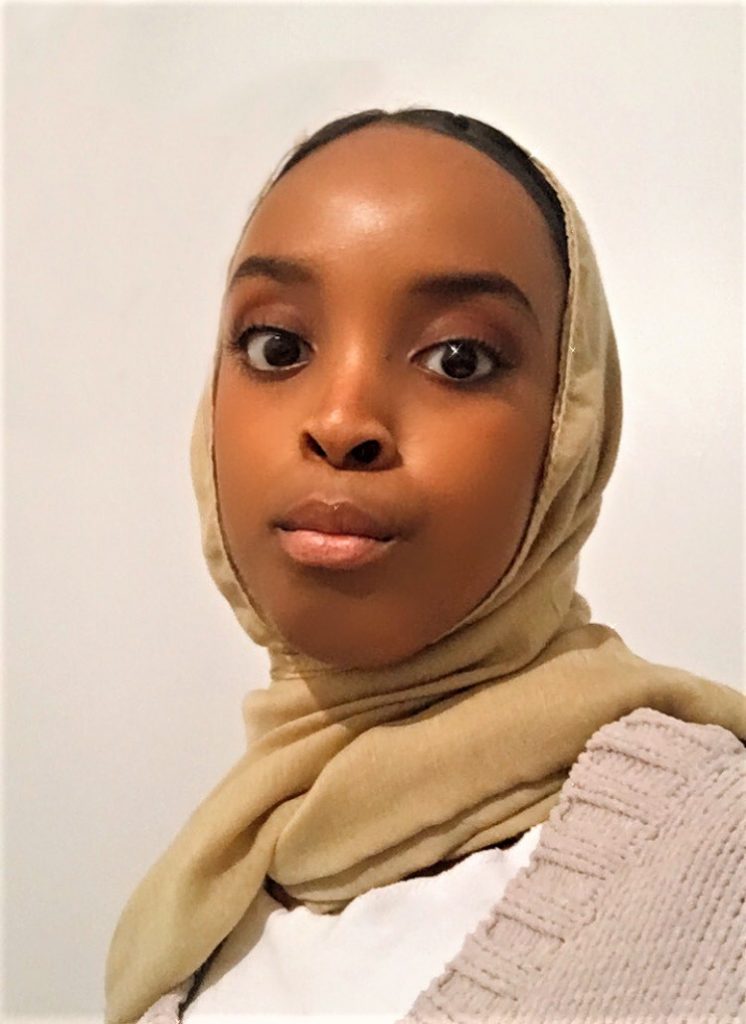 A photograph of Umulkhayr Mohamed. She is looking directly into camera.