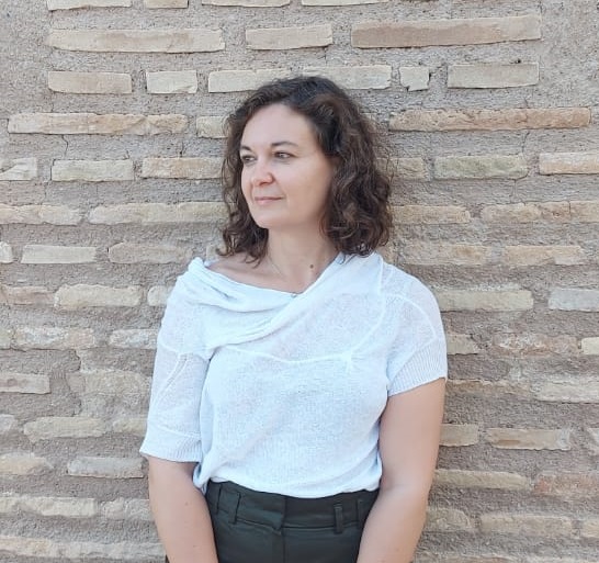 portrait of Francesca standing against a brick wall