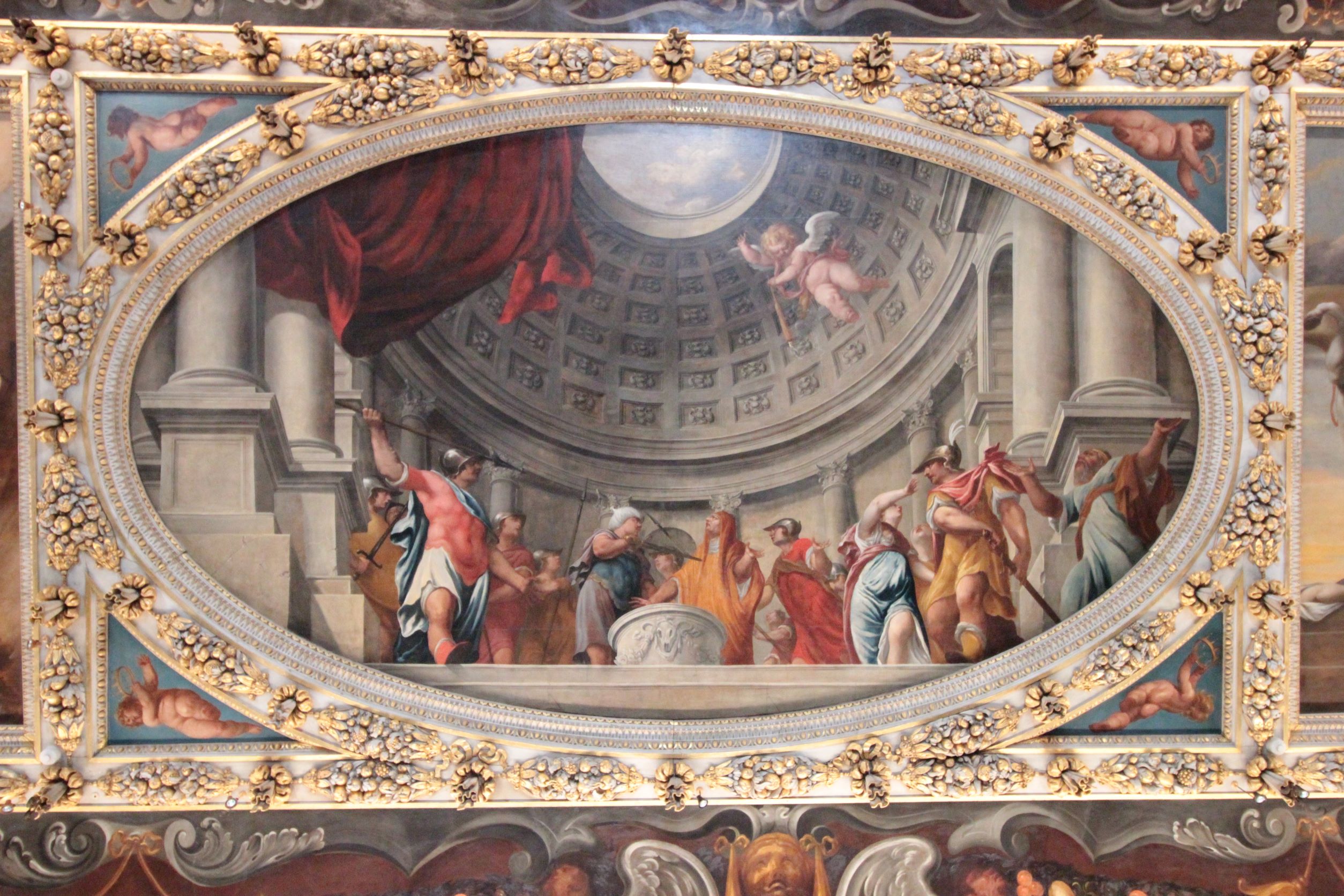 an oval ceiling painting in an ornamental frame, featuring multiple mythological figures