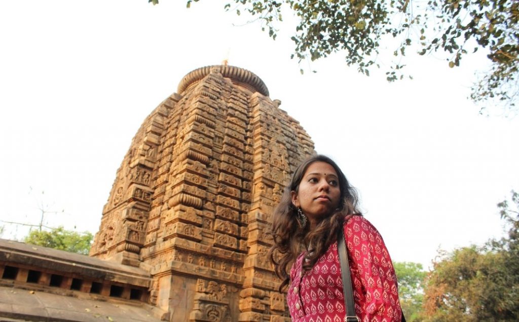 Shreya Sharma standing in front of a monumental structure