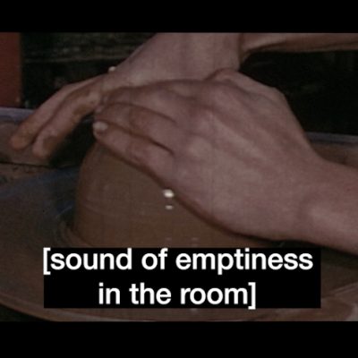Still image from Seo Hye Lee’s artist film titled [sound of subtitles]. The image is split into three identical film frames. Different subtitles are overlaid on each frame. The subtitle on the left reads ‘shaping’, the subtitle on the middle frame reads 'sound of emptiness in the room’, the subtitle on the right reads 'mysterious string music'. In each individual frame, there is a close up of a pair of hands moulding a rotating brown clay clod on the potter’s wheel. All subtitles are white and inside square brackets.