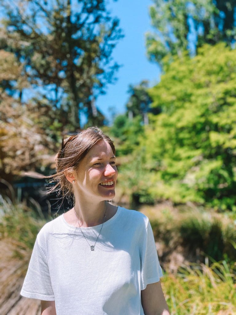 portrait photograph of Susannah Lyon-Whaley standing in sunny woodland