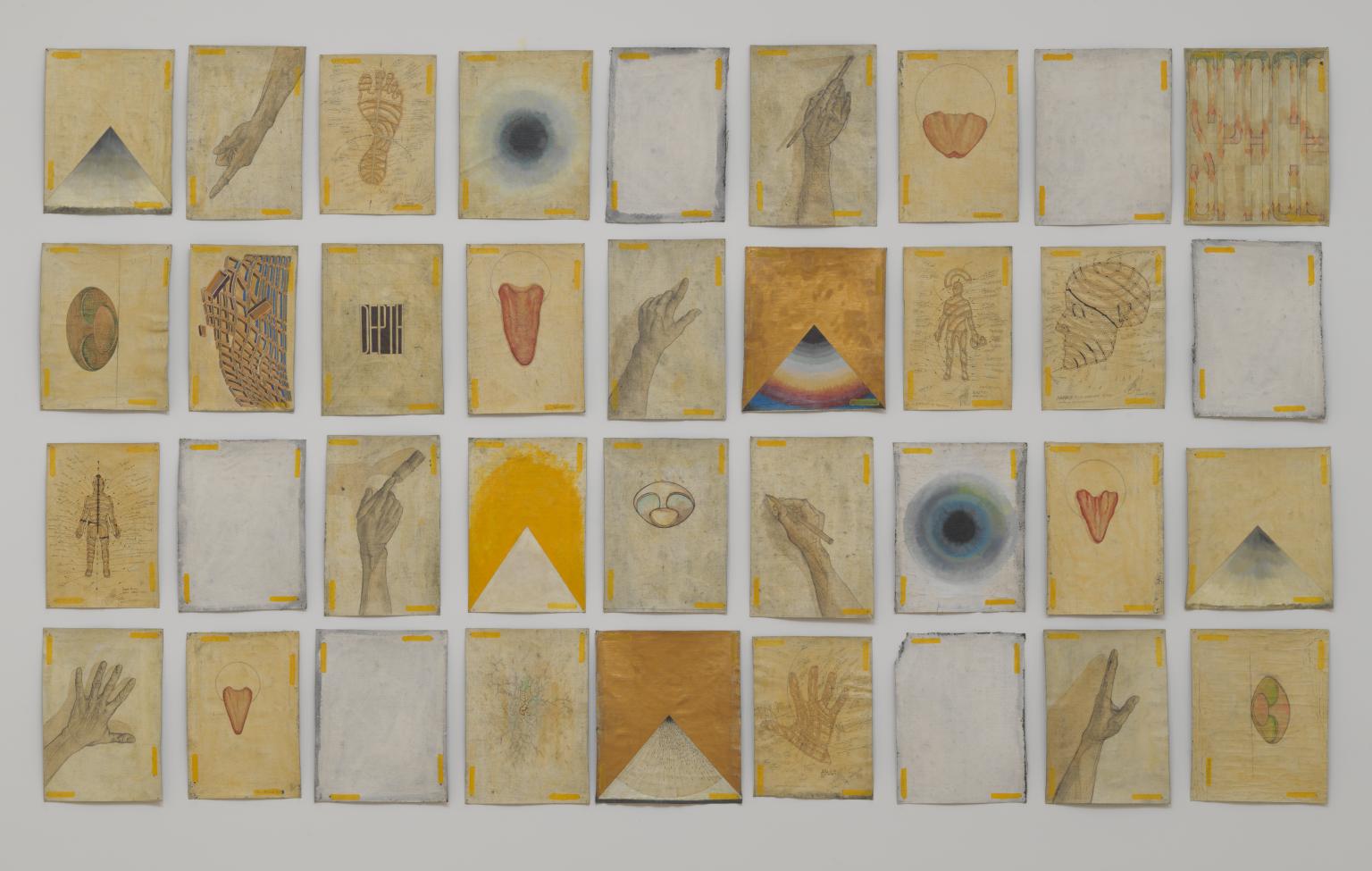 a mixed media work, a grid of 36 squares containing images of various motifs, including hands, eye-forms, and pyramids