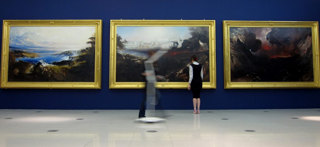 gallery interior, with three large apocalyptic paintings in a row, figures standing on gallery floor befor