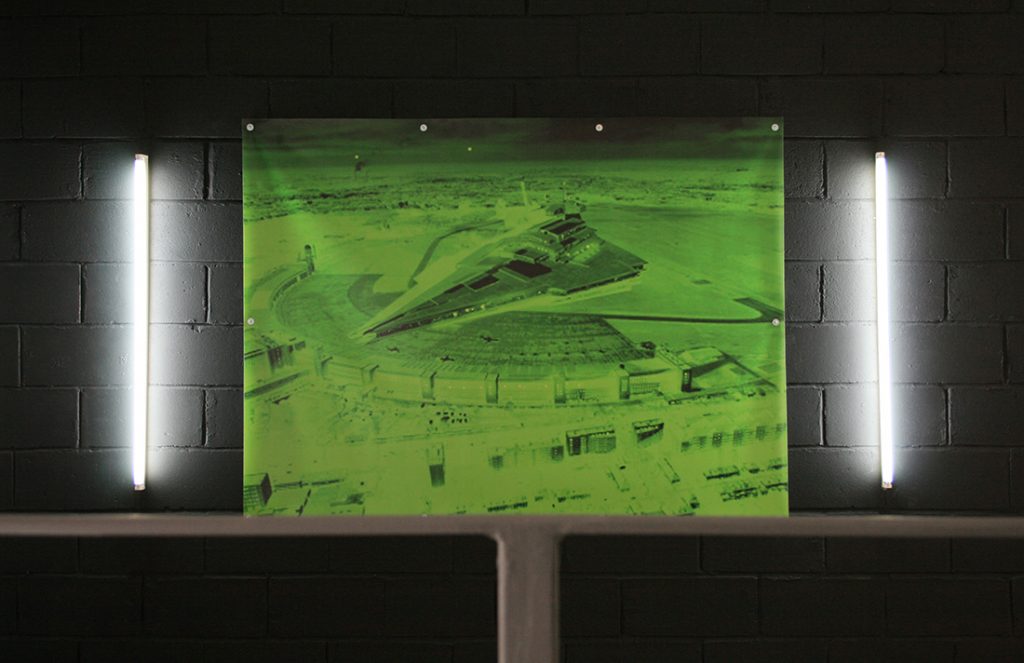 darkened interior view of screen, featuring an all-green monochrome image of a spaceship
