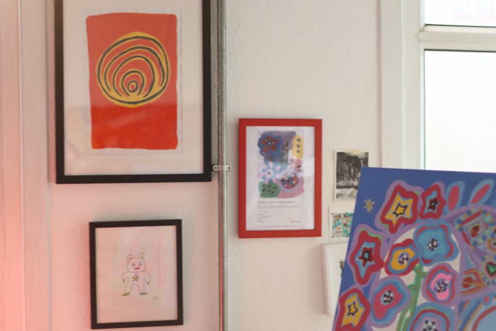several brightly coloured artworks in a white room