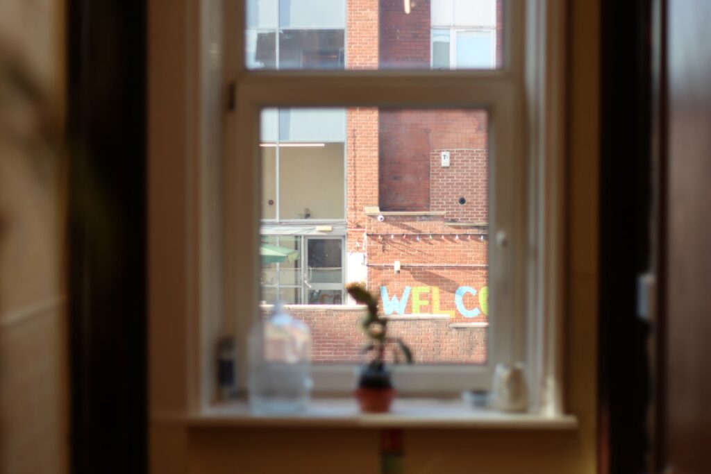 a red brick building as seen through the window of the building opposite it
