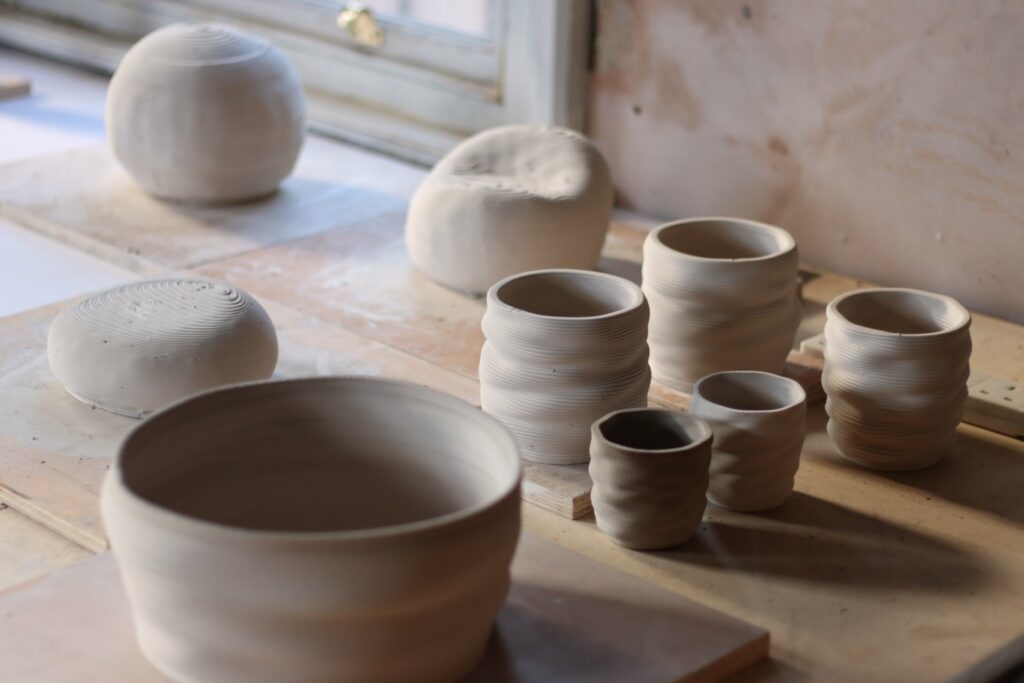 several unfired clay pots